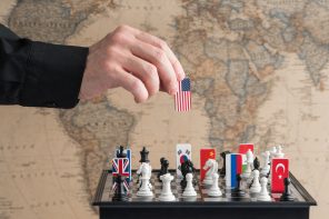 Politician’s,Hand,Moves,A,Chess,Piece,With,A,Flag.,Conceptual